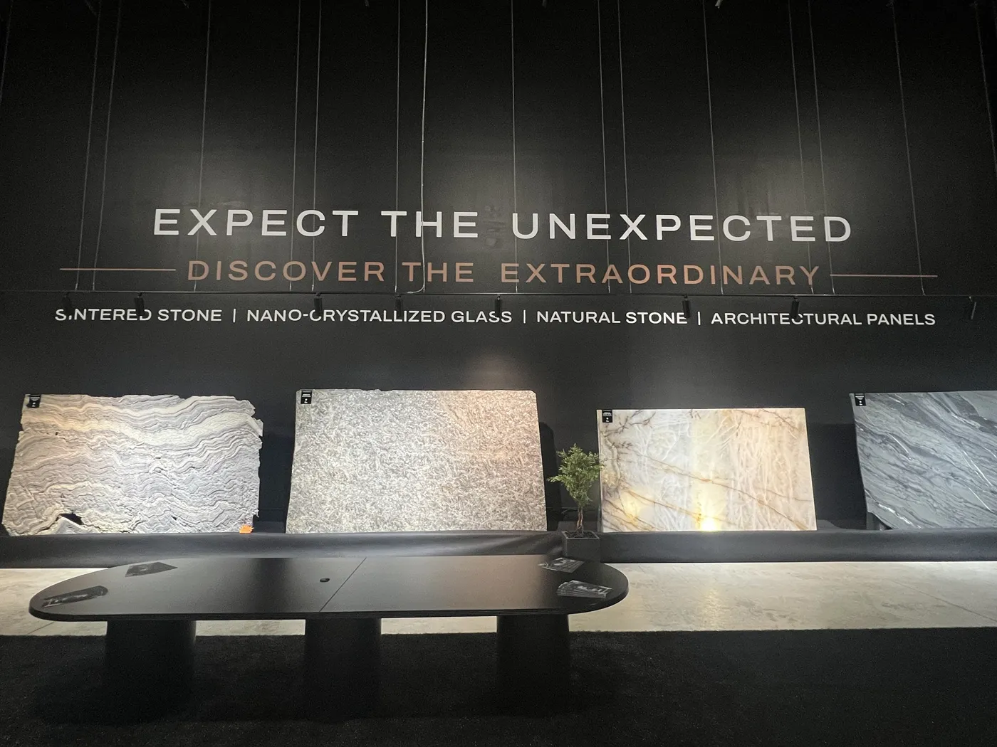 Full slabs on display at the AGL Surfaces Galleria in Stoney Creek, one lit from behind, with a meeting table in front