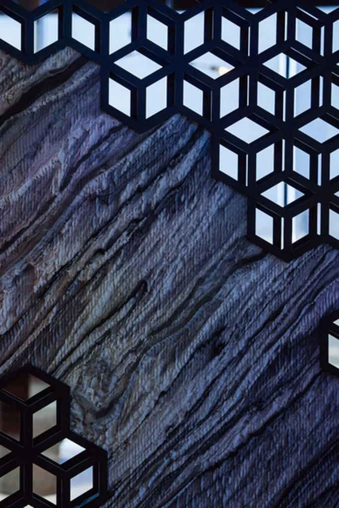 Silver Stream behind a laser-cut steel lattice